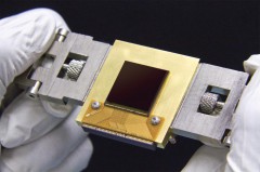 The NEOCam chip has more pixels and better sensitivity than previous generations of infrared sensors. The chip is about the size of a postage stamp and is optimized for detecting the faint heat emitted by asteroids circling the Sun. The NEOCam chip is the first megapixel sensor capable of detecting infrared wavelengths at temperatures achievable in deep space without refrigerators or cryogens. Photo Credit: NASA/JPL