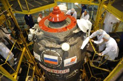 The white-shrouded Kurs antennas are clearly view in this ground processing view of a Progress close-out operation. Photo Credit: Roscosmos