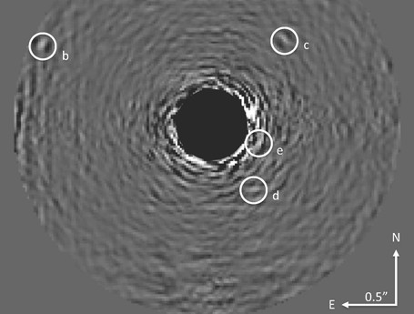 This image shows the HR 8799 planets with starlight optically suppressed and data processing conducted to remove residual starlight. The star is at the center of the blackened circle in the image. The four spots indicated with the letters b through e are the planets. This is a composite image using 30 wavelengths of light and was obtained over a period of 1.25 hours on June 14 and 15, 2012. Image Credit: Project 1640