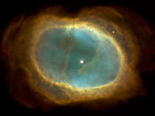 The Ring Nebula, with its dying progenitor star clearly visible. Photo Credit: NASA