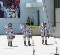 From left to right: Wang Yaping, Nie Haishing and Zhang Xiaoguang head to their bus pre-launch. Photo credit: news.cn. Posted by AmericaSpace.