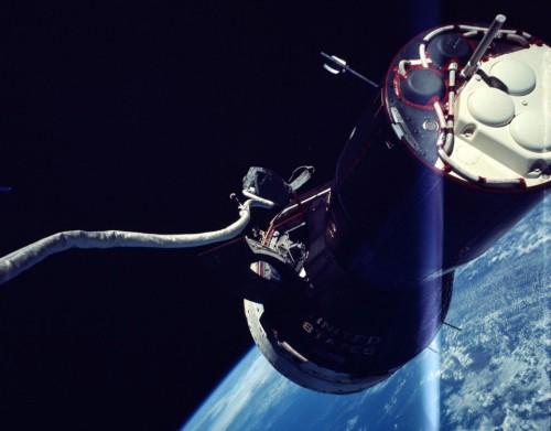 A view of Gemini IX-A, including its maneuvering thrusters, taken by Gene Cernan. His lengthy tether is clearly visible. Photo Credit: NASA
