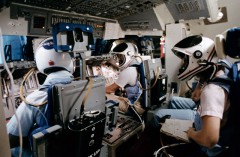 Sally Ride (right) served as the flight engineer, seated behind and between the Commander and Pilot on the Shuttle's flight deck. Her role during ascent and re-entry was to assist with monitoring Challenger's displays and systems. Photo Credit: NASA