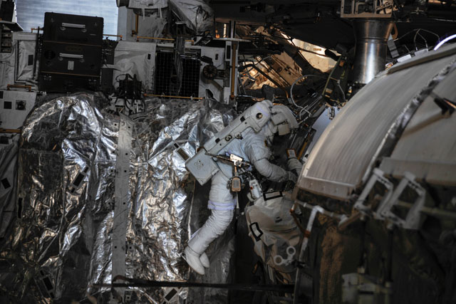 Luca Parmitano works on the routing of data and Ethernet cables during EVA-23. Photo Credit: NASA