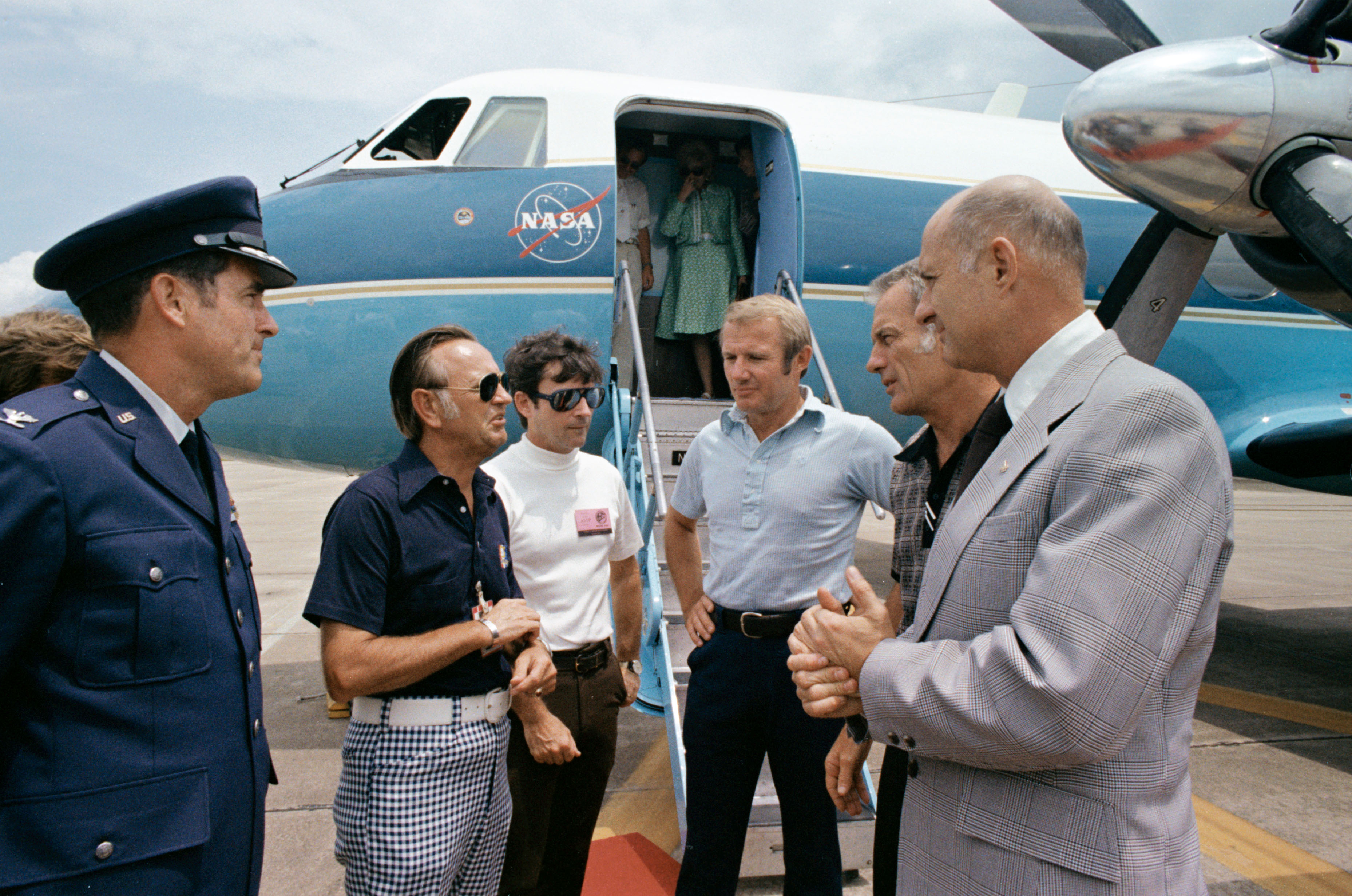 Officials greet the returned Apollo crew at Ellington Air Force Base on 10 August 1975. Left to right are base commander, Col. Donald Robinson, Johnson Space Center (JSC) Director Chris Kraft, Chief Astronaut John Young and Apollo crewman Vance Brand, Deke Slayton and Tom Stafford. Photo Credit: NASA