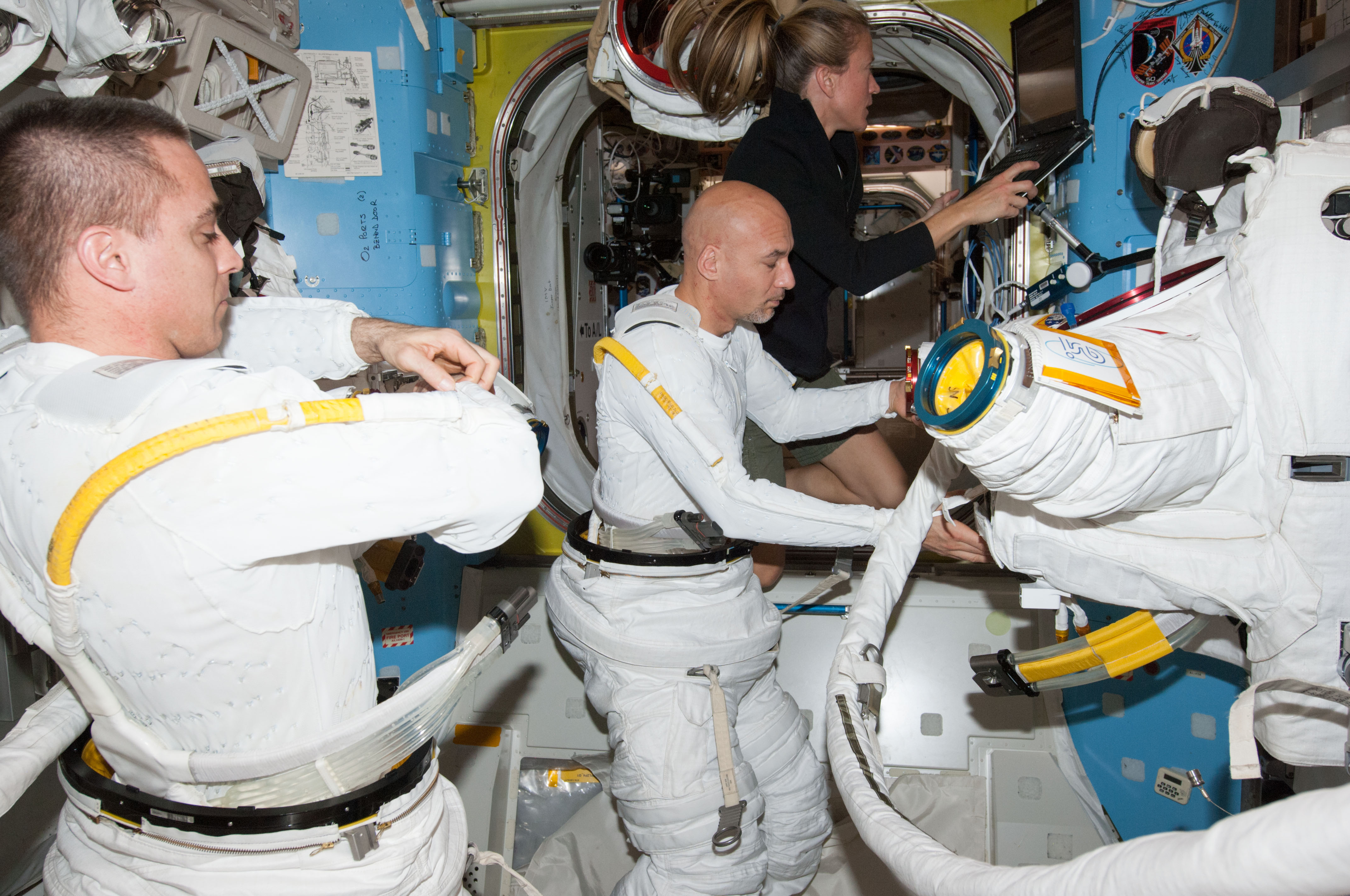 Chris Cassidy (left) and Luca Parmitano check out their suits in the Quest airlock. They will perform a second EVA together on Tuesday 16 July. Photo Credit: NASA