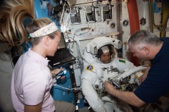 Karen Nyberg (left) and Fyodor Yurchikhin work with a suited Luca Parmitano in the Quest airlock during preparations for the 9 July EVA. Nyberg and Yurchikhin will continue their roles as "intravehicular" crew members on Tuesday's EVA. Photo Credit: NASA