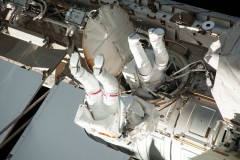 The relative smallness of the Quest airlock is amply illustrated in this view from EVA-22, as Cassidy (with red stripes on the legs of his suit) and Parmitano venture outside. Photo Credit: NASA