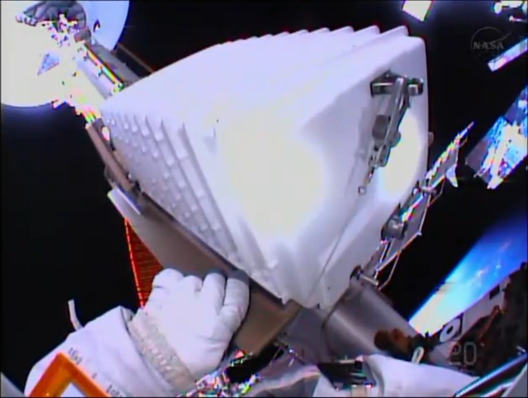 Chris Cassidy's gloved hands manipulate the Space-to-Ground Transmitter Receiver Controller (SGTRC) during today's removal and replacement procedure. Photo Credit: NASA TV