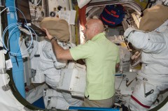 Parmitano at work with U.S. space suits in the Quest airlock. The effort to find and resolve the root cause of the 16 July incident is still ongoing. Photo Credit: NASA