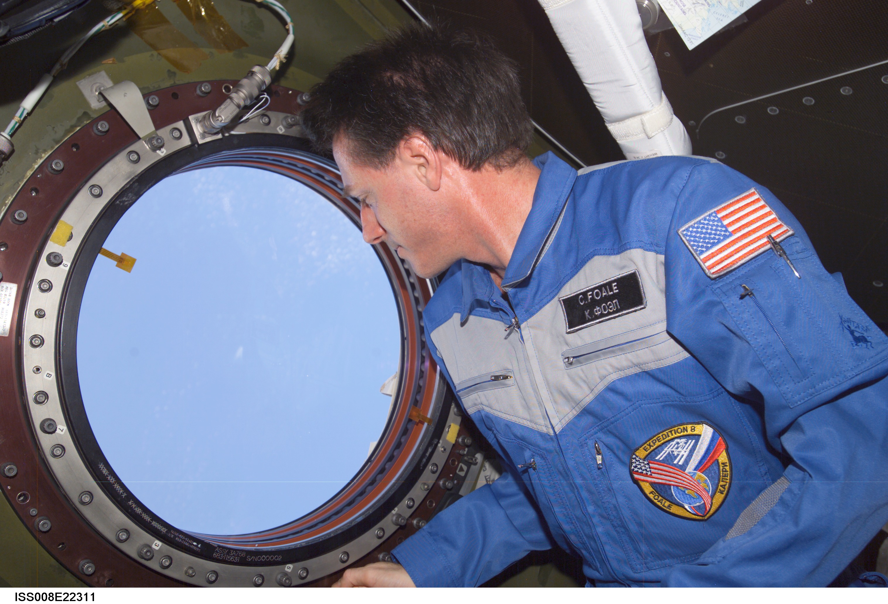 Perhaps aware that his sixth mission would be his last, Foale gazes wistfully through the Destiny laboratory nadir window in April 2004, in the final days of his six-month Expedition 8 mission. Photo Credit: NASA