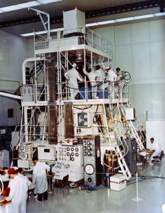 Surrounded by McDonnell technicians, the Gemini V spacecraft undergoes checkout in mid-1965. Photo Credit: NASA