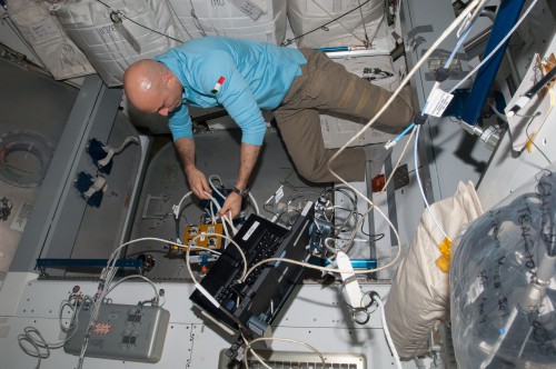 As part of preparations for the arrival of Cygnus, Luca Parmitano works to configure the Common Berthing Mechanism (CBM) Centerline Berthing Camera System (CBCS) inside the space station's Harmony node last week. Photo Credit: NASA