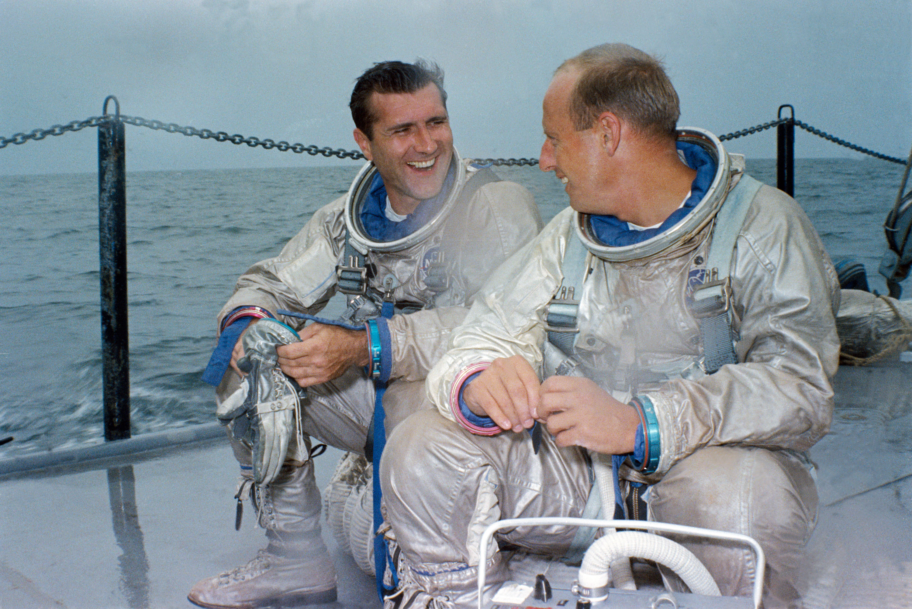 Dick Gordon (left) and Pete Conrad await the start of an emergency water egress training exercise in the Gulf of Mexico in July 1966. Photo Credit: NASA