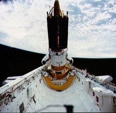 The Boeing-built Inertial Upper Stage (IUS) is here pictured at the base of a NASA Tracking and Data Relay Satellite (TDRS) on an early shuttle mission. Had it not been cancelled, Mission 51E would have delivered a satellite of this type into orbit. Photo Credit: NASA