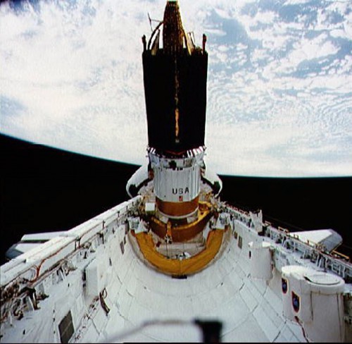 The Boeing-built Inertial Upper Stage (IUS) is here pictured at the base of a NASA Tracking and Data Relay Satellite (TDRS) on an early shuttle mission. Photo Credit: NASA