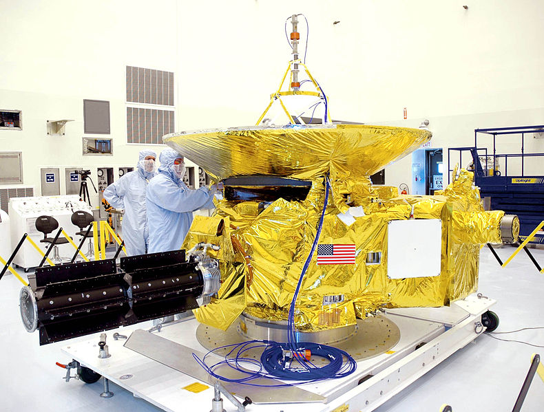 Technicians working on the New Horizons spacecraft in the Payload Hazardous Servicing Facility at NASA's Kennedy Space Center in Florida.  Photo Credit: NASA/KSC