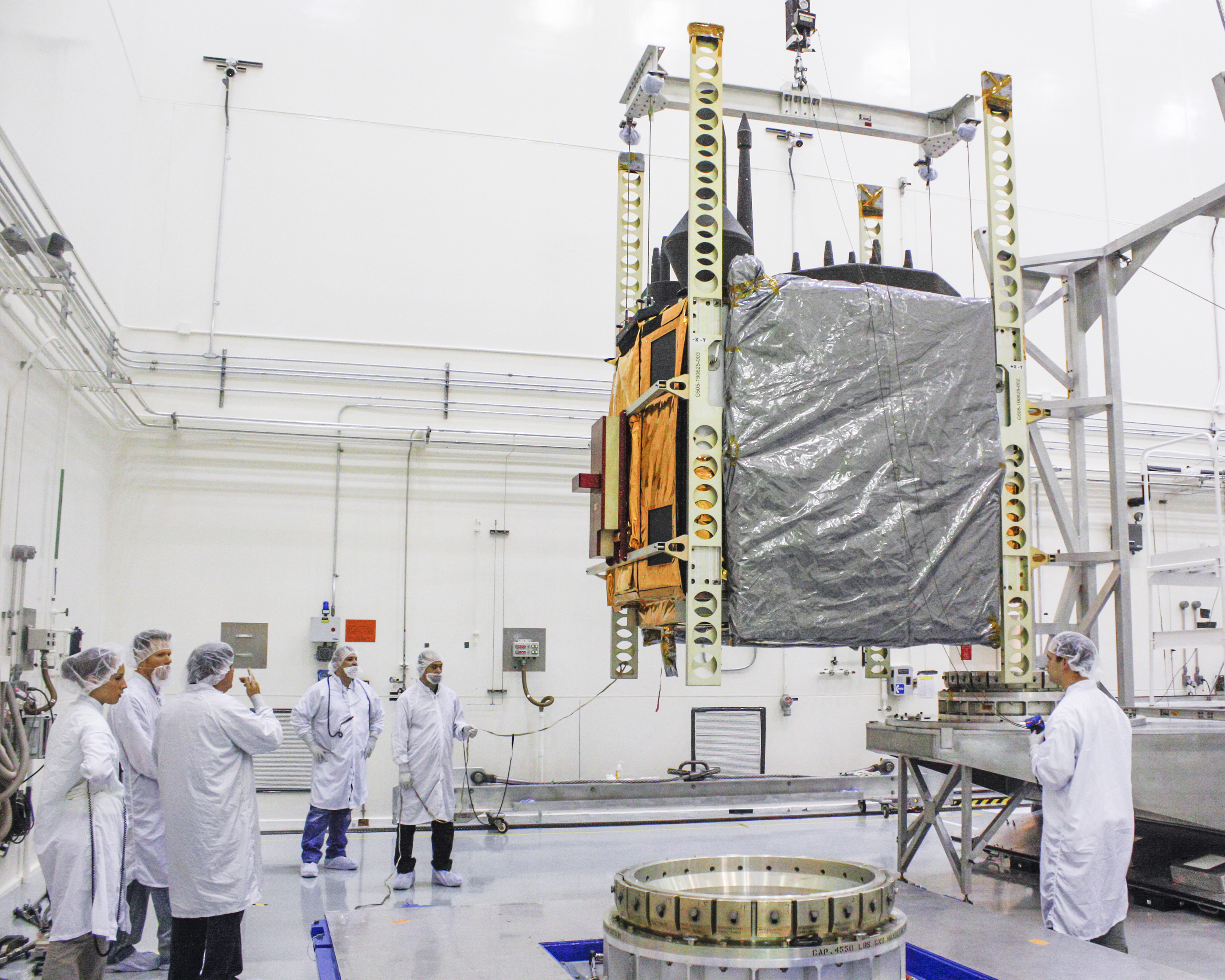 The Global Positioning System (GPS) IIF-5 is moved onto a transporter on 17 September 2013, whilst in clean room conditions at the Navstar Processing Facility at Cape Canaveral Air Force Station, Fla. Photo Credit: Boeing