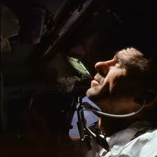 A tired Walt Cunningham glances through one of the command module's windows during the 11-day Apollo 7 mission. Photo Credit: NASA