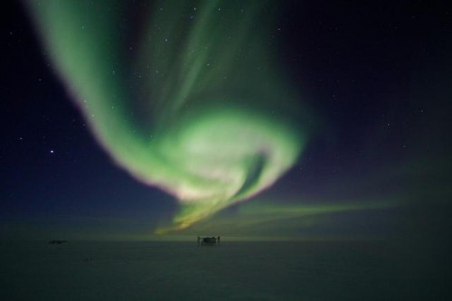 The IceCube Neutrino Observatory Lab under the Aurora Australis. Its Neutrino Detector found evidence of very high-energy neutrinos, coming from outside of the Solar System. Image Credit: Keith Vanderlinde. IceCube/NSF.