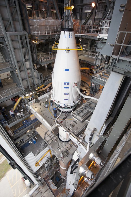 Crews guide NASA's MAVEN spacecraft, inside a payload fairing, into place atop a United Launch Alliance Atlas V rocket at the Vertical Integration Facility at Space Launch Complex 41.  Photo Credit: NASA / Kim Shiflett