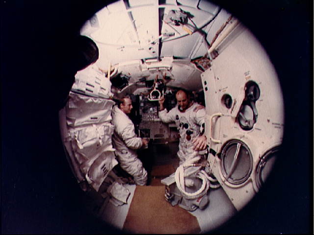 Pete Conrad (right) and Al Bean are pictured aboard the lunar module simulator in October 1969, during Apollo 12 pre-flight training. Photo Credit: NASA
