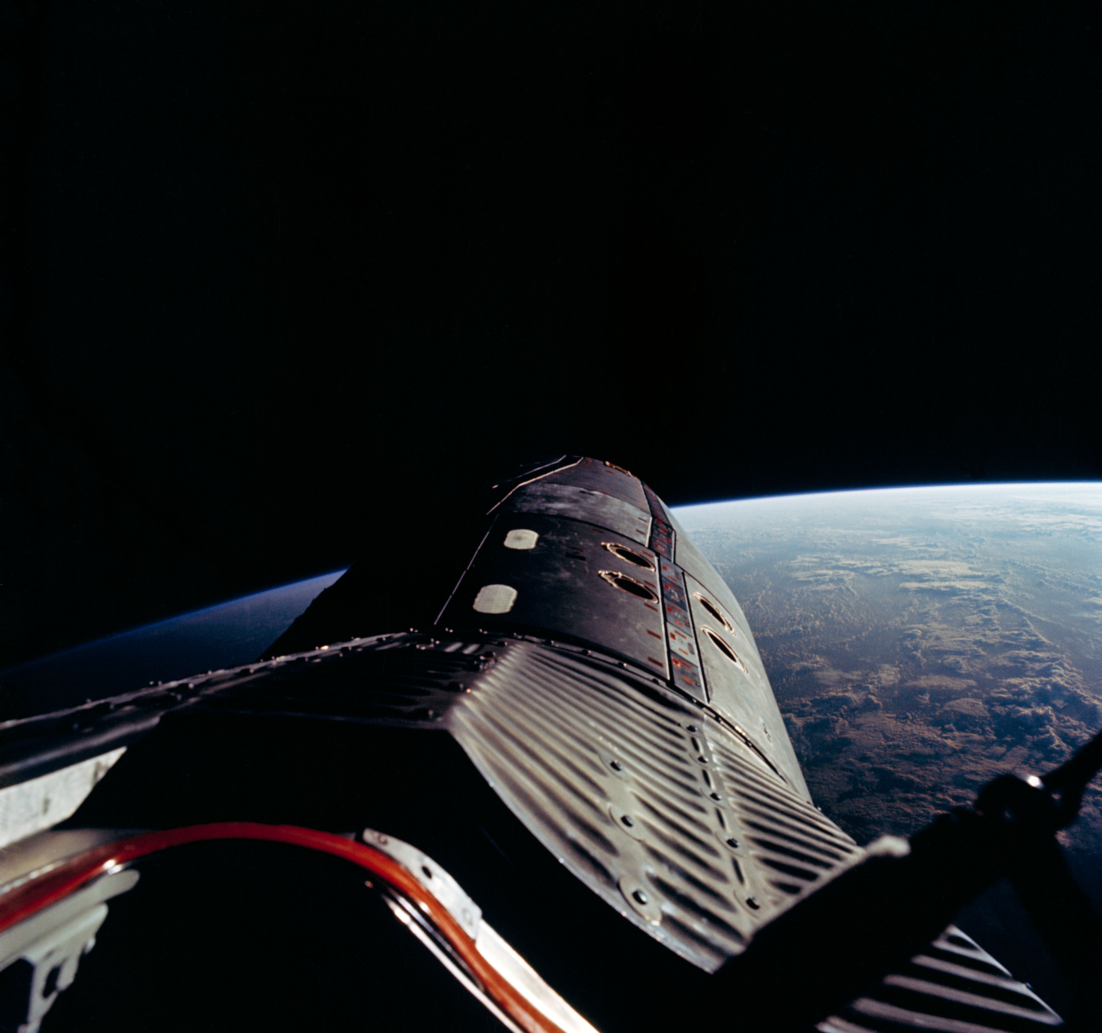 The nose of Gemini XII and the grandeur of Earth, as captured by Buzz Aldrin during one of his sessions of EVA. Photo Credit: NASA