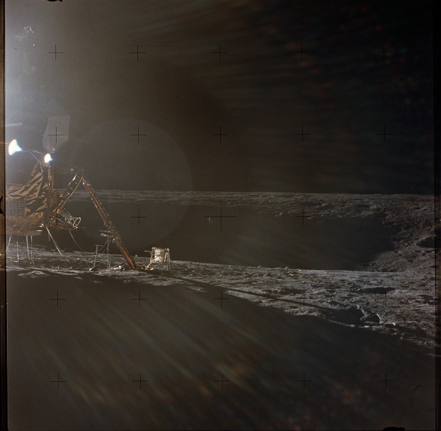 The Apollo 12 lunar module Intrepid (left) and the yawning bowl of Surveyor crater beyond illustrate the outstanding achievement of NASA's trajectory planners in guiding Conrad and Bean to a precision landing point. Photo Credit: NASA