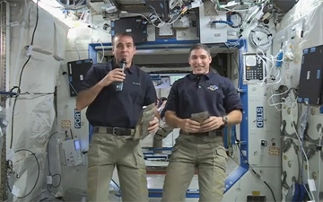 Expedition 38 astronauts Rick Mastracchio (left) and Mike Hopkins deliver their Thanksgiving message from the space station. They paid tribute to their families, to their crewmates, to the Mission Control team and to U.S. armed forces serving worldwide. Photo Credit: NASA