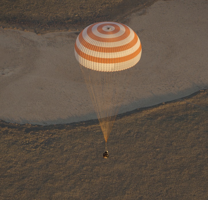 Descending beneath its main parachute, Soyuz TMA-09M approaches touchdown in central Kazakhstan, after 166 days in space. Photo Credit: NASA