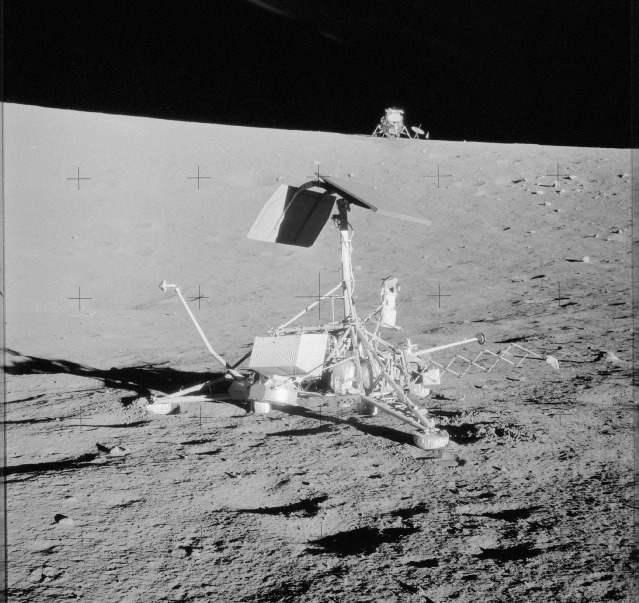The Surveyor 3 landing craft, backdropped by the Apollo 12 lunar module Intrepid, as viewed by Pete Conrad and Al Bean at the Ocean of Storms in November 1969. Photo Credit: NASA