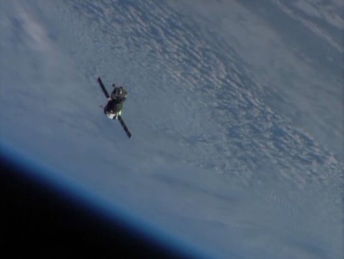 Soyuz TMA-09M drifts into the inky blackness, backdropped by Earth, minutes after last night's undocking from the International Space Station. Photo Credit: NASA TV