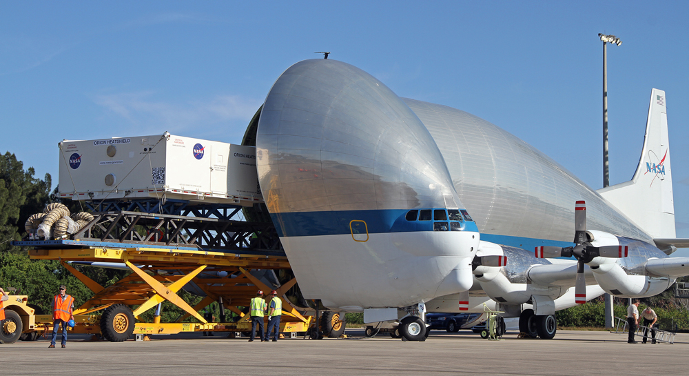 The heat shield for NASA's Orion EFT-1 spacecraft being unloaded off the agency's Super Guppy heavy transport aircraft at Kennedy Space Center last Wednesday.  Photo Credit: AmericaSpace / Shawn Jakway