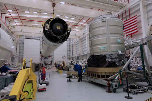 Orbital's Cygnus spacecraft (right) ready to be mated to its Antares rocket (left) which will launch it on a mission to deliver cargo to the International Space Station. Photo Credit: Orbital Sciences Corporation