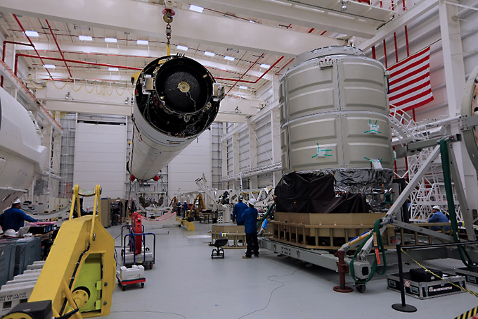 Orbital's Cygnus spacecraft (right) ready to be mated to its Antares rocket (left) which will launch it on a mission to deliver cargo to the International Space Station no earlier than Dec. 19. Photo Credit: Orbital Sciences Corporation