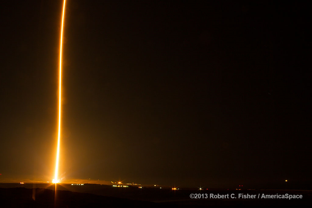 Powered by its single RD-180 engine, the Atlas V 501 soars aloft from Vandenberg Air Force Base, Calif., on 5 December 2013, carrying the NROL-13 payload for the National Reconnaissance Office. Photo Credit: Robert C. Fisher/AmericaSpace