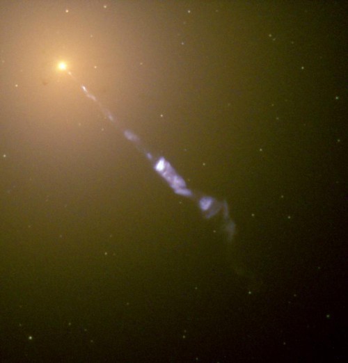 A Hubble Space Telescope photo of M87, an elliptical galaxy with a jet of material streaming out from the black hole lying at its center. Image Credit: NASA and The Hubble Heritage Team (STScI/AURA).