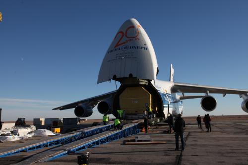 Encased within its protective container, the Inmarsat 5-F1 payload is removed from the Antonov-124 carrier aircraft on 12 November. Photo Credit: ILS