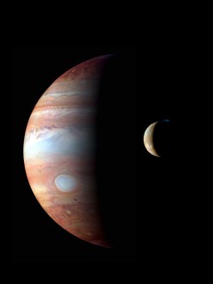 A composite image of Jupiter and Io, taken during New Horizons' fly by of the the giant planet in 2007. The image of Jupiter was taken in infrared and Io's in visible wavelengths. A major eruption is shown in progress on Io’s night side, at the northern volcano Tvashtar. Image Credit: NASA/Johns Hopkins University Applied Physics Laboratory/Southwest Research Institute
