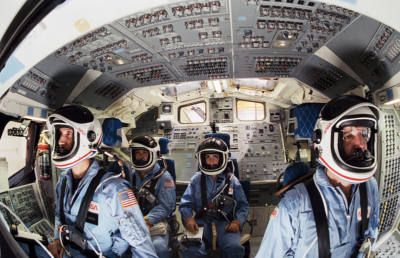 The flight deck members of Mission 51L's crew at their stations for ascent. In the foreground are Commander Dick Scobee (right) and Pilot Mike Smith, with Mission Specialist Judy Resnik behind and between them and Mission Specialist Ellison Onizuka at her right side. The other crew members sat on the middeck for ascent. Photo Credit: NASA