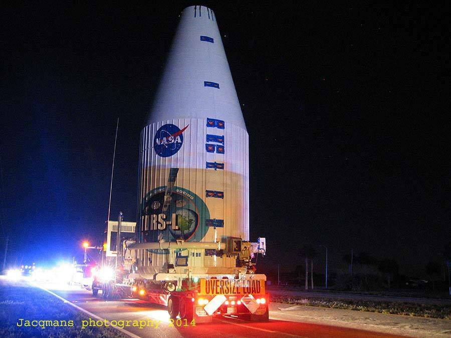 Pictured in the pre-dawn darkness of Monday, 13 January, during rollout from Astrotech's payload processing facility to SLC-41 at Cape Canaveral Air Force Station, the TDRS-L payload shroud is emblazoned with the mission logos. Photo Credit: Jacques van Oene/AmericaSpace