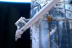 The Wide Field Camera 3 (WFC3) was installed on Hubble during the telescope's Servicing Mission 4 STS-125 flight in May 2009. Here, astronaut John Grunsfeld completes the final tasks of the Hubble repairs. The superior capabilities of the WFC3 camera, made the Frontier Fields program possible. Image Credit: NASA