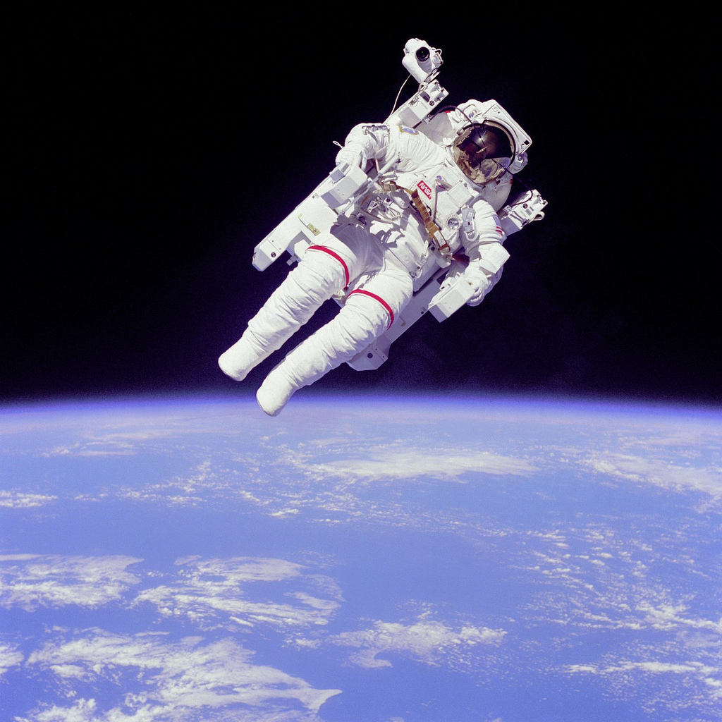 This iconic image, captured by astronaut Robert "Hoot" Gibson, shows Bruce McCandless participating in humanity's first untethered EVA, aboard the Manned Maneuvering Unit (MMU). Photo Credit: NASA