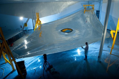 A full-scale JWST sunshield membrane deployed on the membrane test fixture, ready for a precise measurement of its three dimensional shape. The JWST sunshield comprises five of these layers, each of which has to be precisely spaced with respect to the next. Photo Credit: Northrop Grumman
