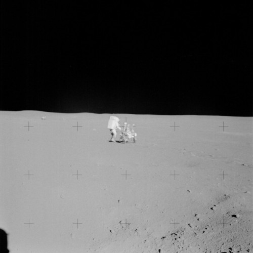 Ed Mitchell works with the Mobile Equipment Transporter (MET), surrounded by the barren desolation of the Fra Mauro landing site. Photo Credit: NASA