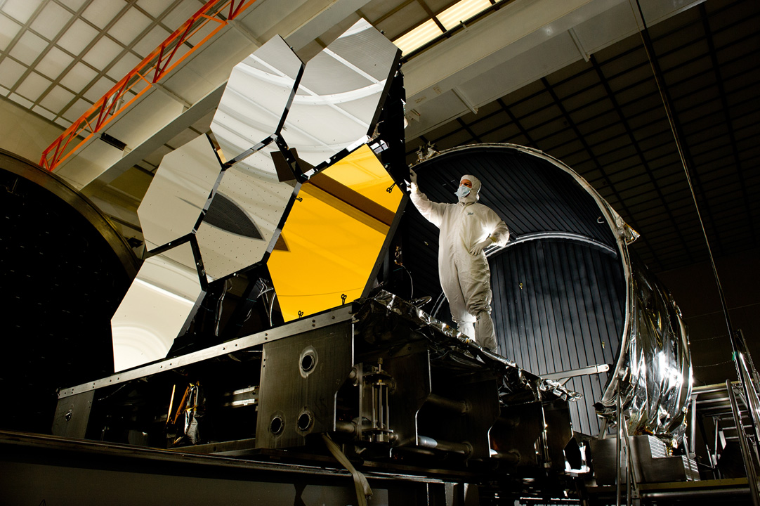 Ball Aerospace lead optical test engineer Dave Chaney inspects six primary mirror segments, critical elements of NASA's James Webb Space Telescope, prior to cryogenic testing in the X-ray and Cryogenic Facility at NASA's Marshall Space Flight Center in Huntsville, Ala. The James Webb Space Telescope will be launched in 2014 to study the formation of the first stars and galaxies and shed new light on the evolution of the universe. Credit: NASA/MSFC/David Higginbotham