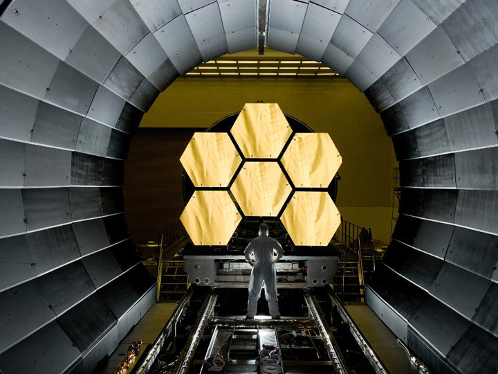 NASA engineer Ernie Wright looks on as the first six of eighteen flight ready James Webb Space Telescope's primary mirror segments are prepped to begin final cryogenic testing at NASA's Marshall Space Flight Center. Photo Credit: NASA/MSFC/David Higginbotham