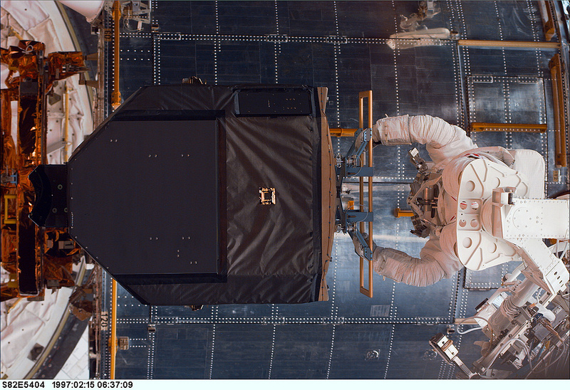 Greg Harbaugh works to manhandle the Fine Guidance Sensor (FGS) into position on EVA-2. Photo Credit: NASA