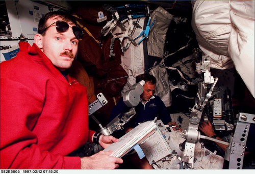 It was often said that on EVA days, the preparations for the spacewalk completely took over the middeck, as this view of Steve Smith (left) and Mark Lee at work on 12 February 1997 illustrates. Photo Credit: NASA
