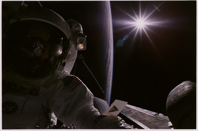 Barely illuminated by sunlight, Joe Tanner is pictured during EVA-4 on STS-82. Photo Credit: NASA
